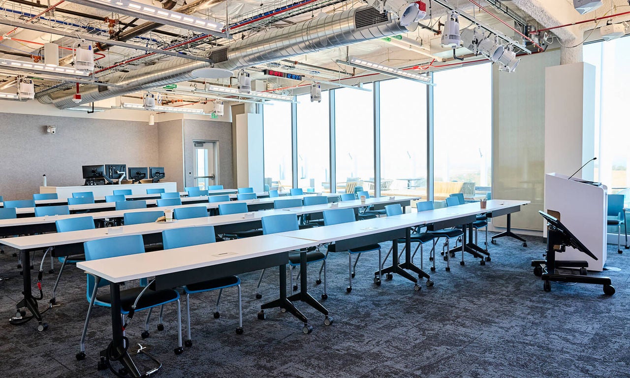 Our rooms can be configured for various formats, including theater-style seating, collaborative pods, classroom-style, and open networking.
